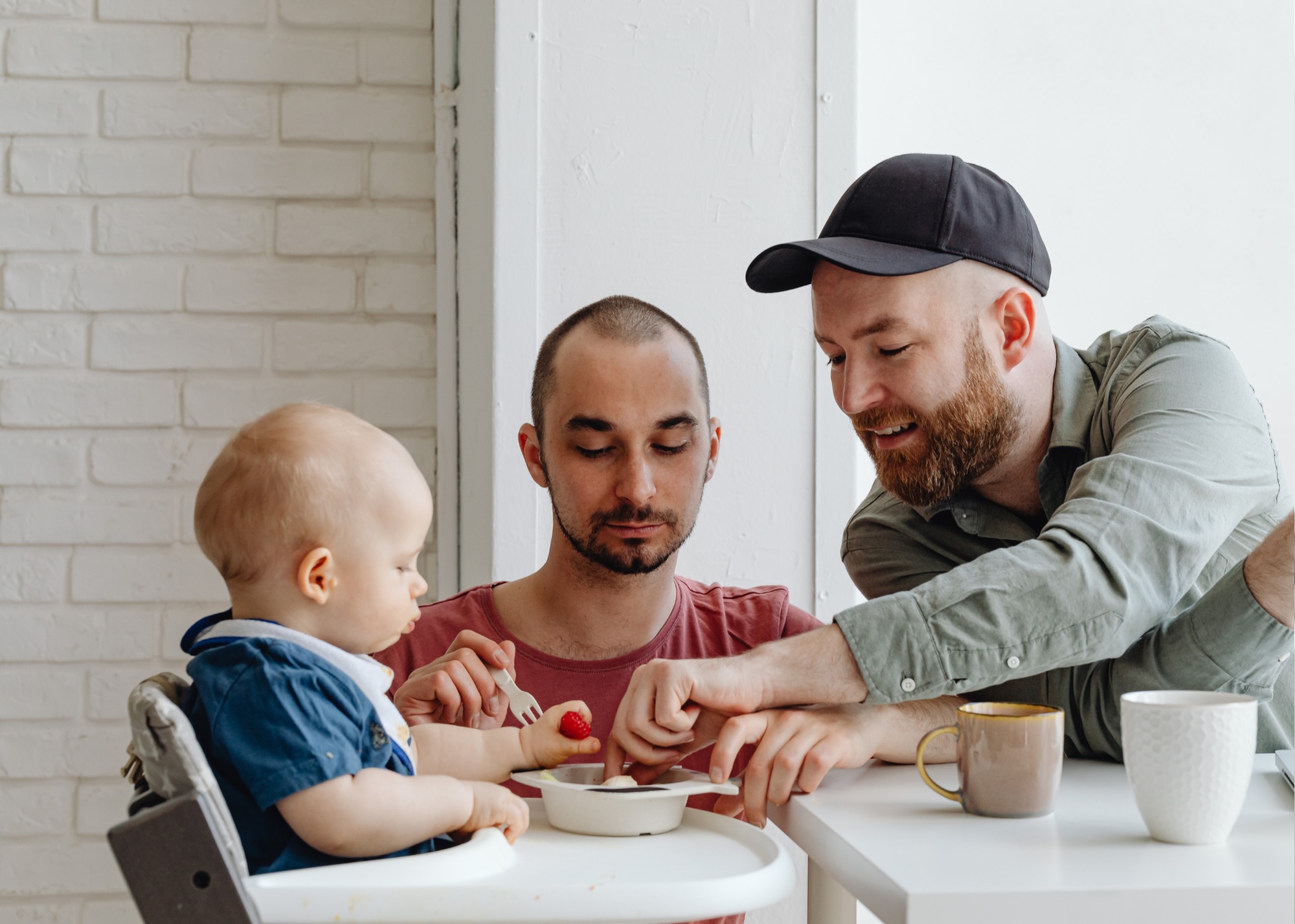 Father feeding baby in highchair